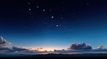 Majestic Ursa Major constellation gleams brightly in the serene deep blue twilight sky above the dark silhouette of mountains and soft clouds at the horizon.