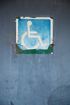 Close up of signs on public restroom toilet doors - disabled access