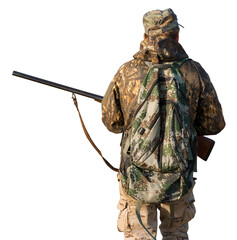 Hunter man in camouflage with a gun during the hunt in search of wild birds or game.