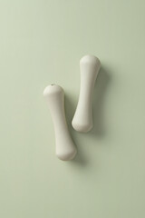 Fototapeta premium 1kg dumbbells on green background. Fitness training and strength training at home concept