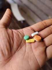 some medicine pills in the palm of the hand