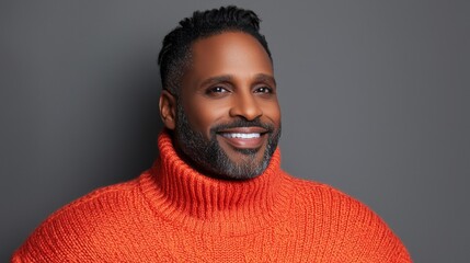Obraz premium Man with a beard and sweater smiling contentedly in a cozy atmosphere surrounded by nature and warm colors