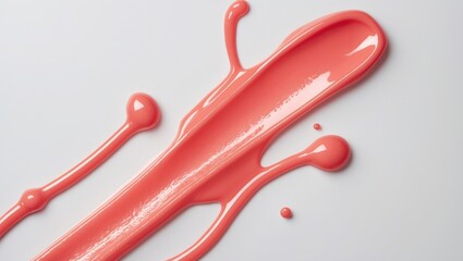 Swatch texture of lip oil or lip gloss. Isolated smear of glossy liquid lipstick on background. Stroke of red makeup product.