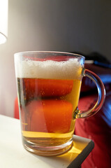 Glass of beer is sitting on a table