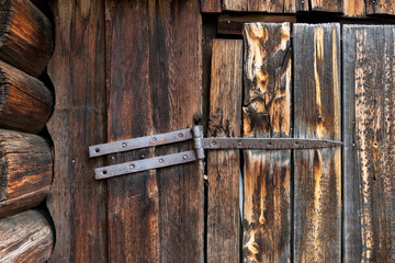 Wooden Fence Door View with Weathered Wall Planks, Old Rusty Hinges. Agricultural Livestock Building Tree Texture Background	