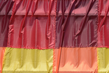 mostly red and burgundy fabric swatches with yellow and orange outdoors