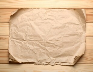 Obraz premium Crumpled brown paper on light wooden background. Perfect for design, texture, or mockup.