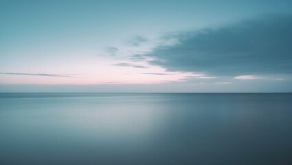 Panoramic long exposure image of tranquil water, clouds, and horizon at dawn