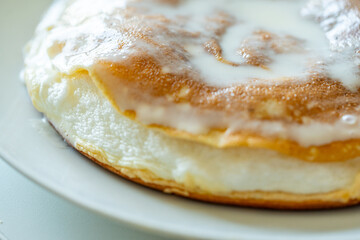 Slice of omelette poulard with pancakes on a light background. close-up