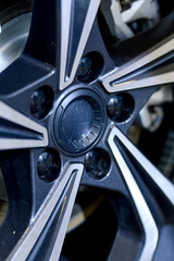 Car wheel with brake calipers and stylish design.
