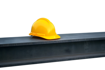 Yellow construction helmet on a steel beam. Space for text.