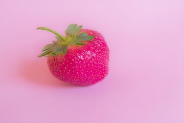 Strawberry on solid pink background close up