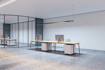 Modern empty corporate office with minimalist desks, computers, and glass partitions in a clean contemporary workspace interior concept. 3D Rendering