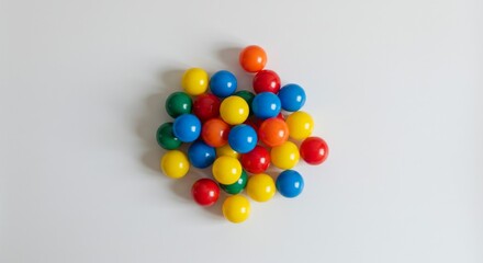 Obraz premium Colorful plastic balls arranged in a playful cluster on white background 