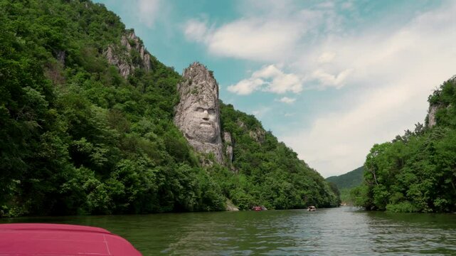 Decebal's (Decebal Rex)face carved into the rock seen from the Danube, 4k