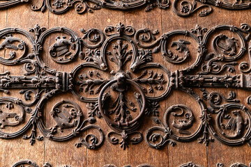 Paris, France-April 16, 2025: Ornate Ironwork on Notre-Dame Wooden Door