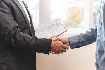 Client and banker shaking hand after lease contract successful