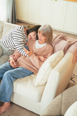 family concept lovely mother and daughter lying down embrace bonding relation stay home spending...