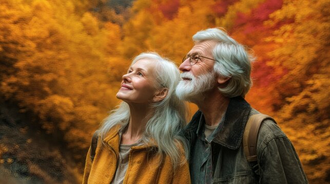A loving senior couple gazing up at the autumn leaves, enjoying a beautiful day together - Powered by Adobe