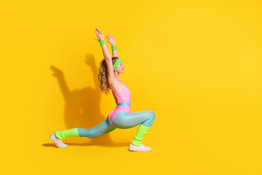 Colorful retro workout with young female athlete in vintage bodysuit on yellow studio background