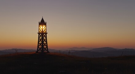 Lighthouse Silhouette Against Warm Sunset Hues and Rolling Hills