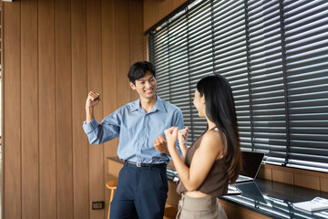 Business Engagement and Team Spirit. Young professionals celebrating success in a modern office.