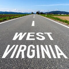 Open road in west virginia countryside with clear blue sky and distant mountains