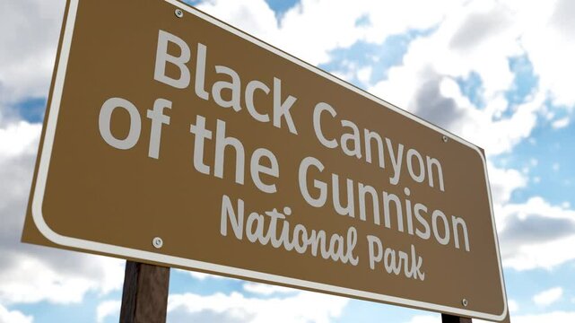 Black Canyon of the Gunnison (Colorado) National Park Road Sign Against Blue Sky and Clouds. One of The US National Parks Series.