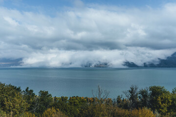 sevan big lake in the mountains windy day in rural armenia with autumn brown leaves 