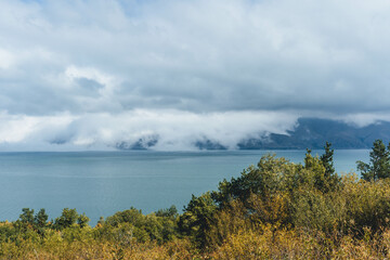 sevan big lake in the mountains windy day in rural armenia with autumn brown leaves 