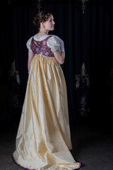 Fototapeta premium A Regency woman wearing evening attire, including an embroidered dress and a long spencer with gloves