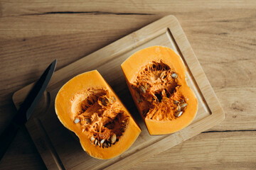 Pumpkin on a wooden cutting board is perfect for delicious fall recipes.