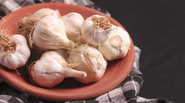 Side pan shot of garlic in a bowl