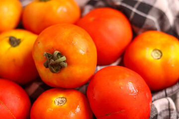 Fresh red tamotoes with kitchen cloth and kept in a bowl, healthy vegetable in the kitchen