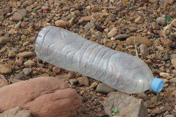 A plastic bottle lying on the ground, Plastic pollution, Plastic environmental impact