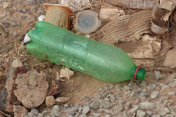 A plastic bottle lying on the ground, Plastic pollution, Plastic environmental impact