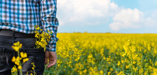 farmer in mustard field. Selective focus.