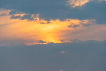 Serene landscape photo of sun settingrising behind clouds, evoking feelings of calmness and tranquility Ideal for marketing materials related to relaxation, travel destinations, or lifestyle produc