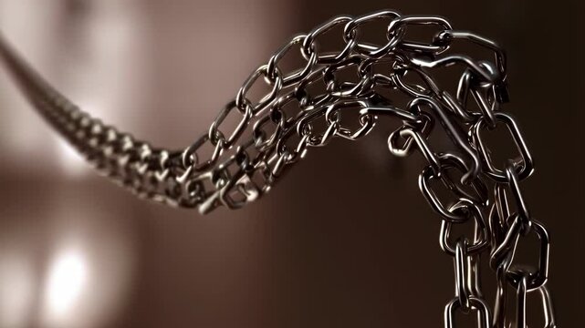 Macro close-up on silver metal chain links showing interconnectivity and interdependence in looping, waving patterns on brown background.