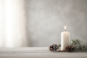 serene minimalist christmas setting featuring single candle as focal point