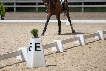 
a dark green and black fence or barrier that looks like the border of a riding arena or riding...