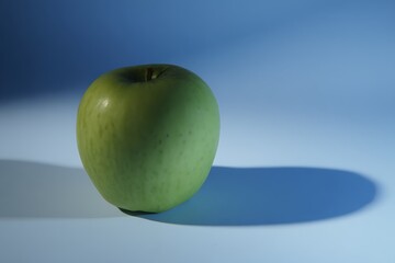 Granny Smith apple on blue background