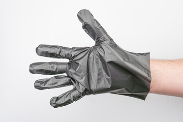 Close-up view of a black disposable hygiene glove against a neutral background, product-focused...