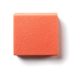 Obraz premium Closeup of a Coral Colored Rectangular Block on a Textured Surface