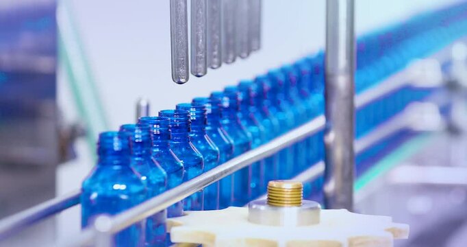 Pharmaceutical manufacturing line for liquid medicine production, automatic bottle filling machine for syrup, sanitizer, or gel in plastic bottles at sterile industrial packaging facility
