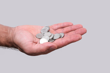 Closeup of Ukrainian hryvnia coins in hand, money on clean gray background. for financial or...