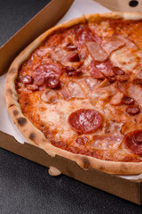 Italian pepperoni pizza with cheese and salami, tomatoes and sauce