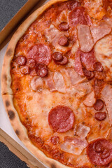 Italian pepperoni pizza with cheese and salami, tomatoes and sauce