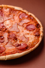 Italian pepperoni pizza with cheese and salami, tomatoes and sauce