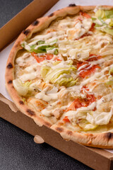 Italian caesar pizza with cheese and chicken, lettuce leaves and sauce